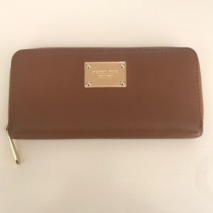 Michael Kora camel colored zip wallet.